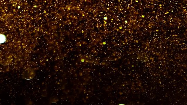 	
golden waves motion abstract of particles gold dust with stars on black background. wave background gold movement, seamless loop in 4k resolution.	
