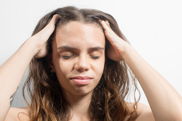 Naklejka premium Portrait of a young blonde Latin American woman with hands on head and upset expression