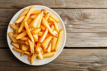 delicious french fries in a bowl and ketchup on a wooden table