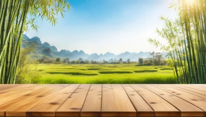  Wood table with bamboo and beautiful sunny nature background with copy space © cobaltstock