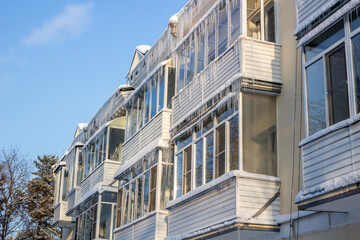 Obraz premium Glazed balconies in icicles in winter day