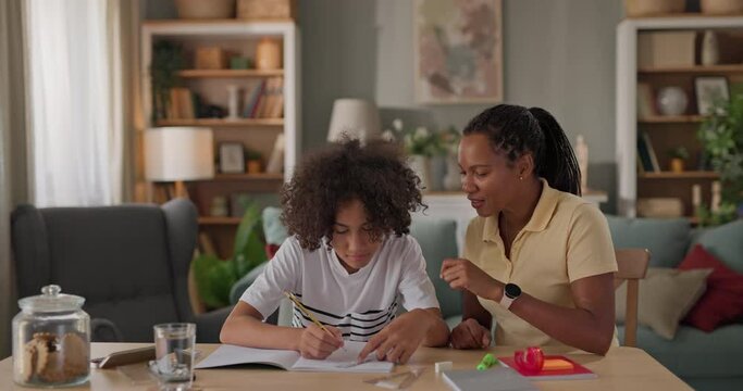 Mom helping a teenage son study for exam at home