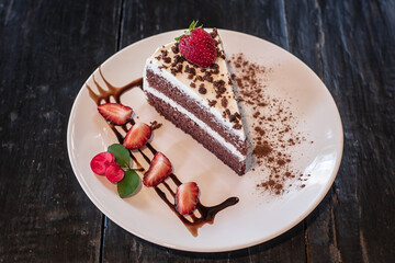 Chocolate cheesecake with fresh berries and strawberry in the plate.