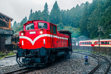 The iconic red train is turning near the station at Alishan National Park, Taiwan.