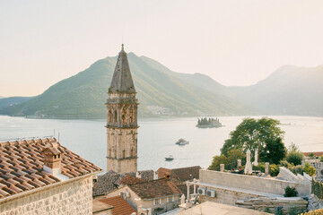 Bell tower of the Church of St. Nicholas against the background of the island of St. George in the...