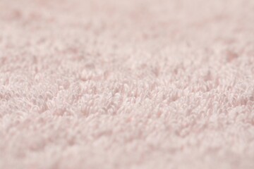 Texture of soft light pink fabric as background, closeup