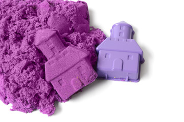 Castle made of purple kinetic sand and plastic mold on white background, top view