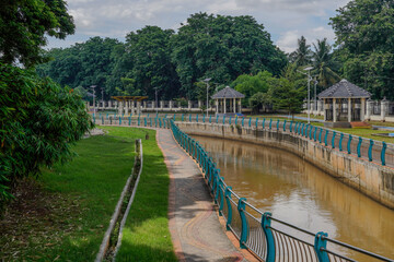 The river in the beautiful Serpong city park with a bright sky as a background. - obrazy, fototapety, plakaty