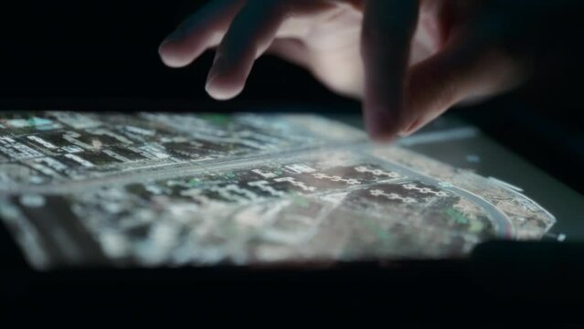 Person rotating a satellite view map on a tablet using fingers. Close up, slow motion. 