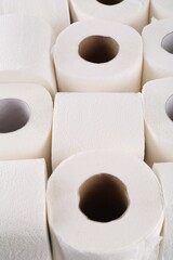 Many soft toilet paper rolls as background, closeup