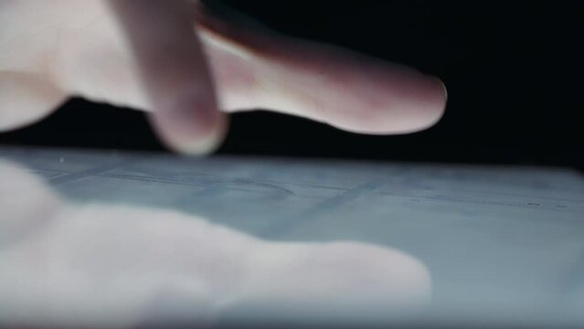 Close up of fingers rotating a city map on a tablet.Slow motion. 