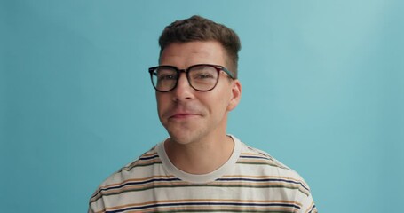 Man, face and glasses for vision and eye care, spectacles choice and check designer frame with prescription lens. Smile in portrait, eyewear and optometry for health and wellness on blue background