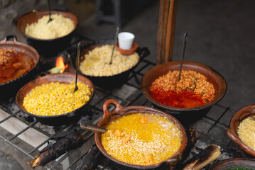 Traditional Mexican Corn Dish Known As Esquites close up, which is corn cooked in chicken broth with epazote herb and seasoned with mayonnaise, shredded white