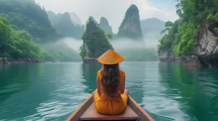 Rolgordijnen traveler woman with wooden hat in a longtail boat at Khao Sok Lake Thailand Asia, Asian woman in a boat at the lake with limestone cliffs © Fokke Baarssen