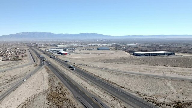 I 40 Interstate outside Albuquerque, New Mexico with traffic moving and stable wide shot drone video.