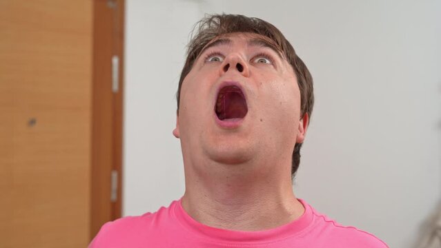 Tired, overtired portrait suddenly bulges eyes, sharply opens mouth, falls unconscious, feigns grimace, pretending to be sick Heart attack, insurance, ambulance advertising Unexpected comical fainting