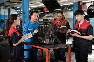 Specialist lecture, a male supervisor engineer train and describe automotive engines with mechanic worker staff teams for repair work at car service garage and maintenance jobs in automobile industry.