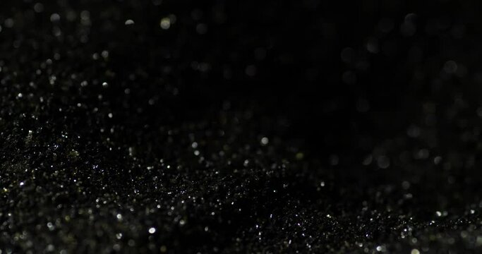 Macro closeup of shiny dark black gunpowder, detail shot, background