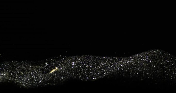 9&times;19mm Parabellum Cartridges Dropping Into Heap Of Bullet Grains. closeup, slow motion shot