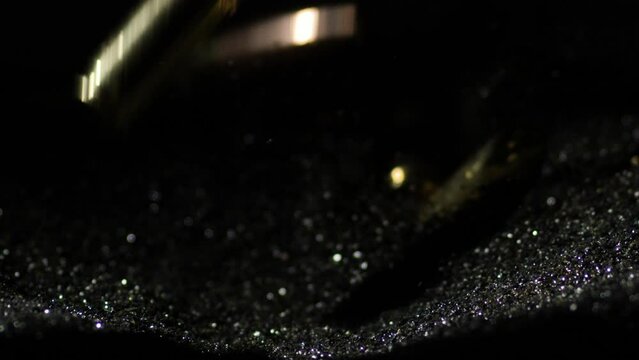 9&times;19mm Parabellum and 300 AAC Blackout bullets falling on pile of gunpowder