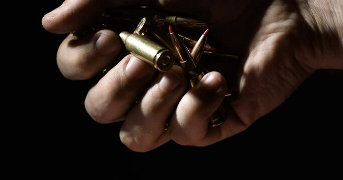 .300 AAC Blackout Plastic Tipped Falling From Hand Of Man. - close up, slow motion