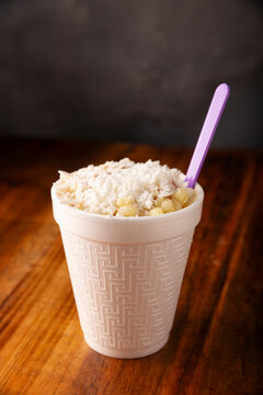 Esquites. Corn kernels cooked and served with mayo, sour cream, lemon and chili powder, very popular street food in Mexico, also known as Elote en Vaso. The recipe varies depending on the region.