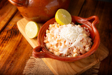 Esquites. Corn kernels cooked and served with mayo, sour cream, lemon and chili powder, very popular street food in Mexico, also known as Elote en Vaso. The recipe varies depending on the region.