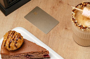 the bank card is on the table in the coffee shop next to the cof