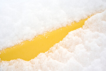 Yellow pipe covered under dense snow