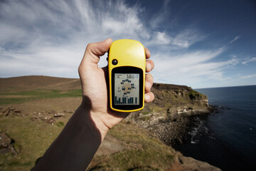 Hand Holding Yellow GPS Navigator, Reykjanes, Iceland