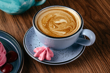 cappuccino in a mug and dessert on a plate. coffee shop menu