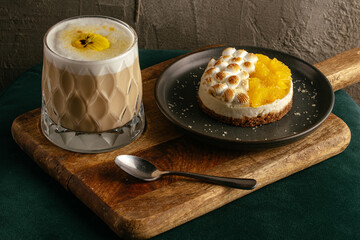 coffee in a glass cup and dessert on the table in the coffee sho