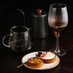 coffee in a glass cup and dessert on the table in the coffee sho