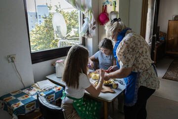 grandmother and granddaughter bake apple pie. generations. family
