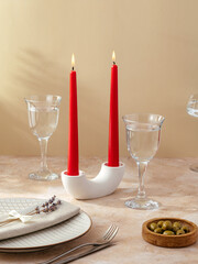 candles stand on the table in a tall stone candlestick.  the tab