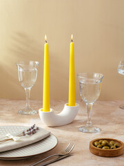 candles stand on the table in a tall stone candlestick.  the tab