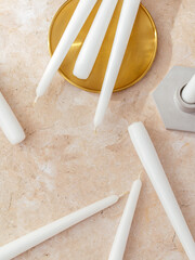 whole candles are lying on the table.