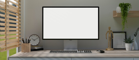 A modern, minimal white home office workspace with a white-screen computer mockup on a table.