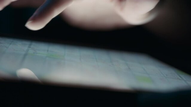 Close up of fingers rotating a digital map on a tablet.Slow motion. 