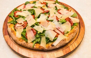 Basil pizza, with mozzarella, sun-dried tomatoes, arugula. Italian style pasta.