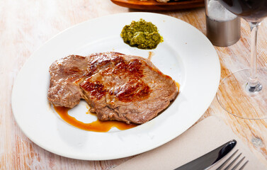 Delicious fried beef entrecote served with pesto sauce