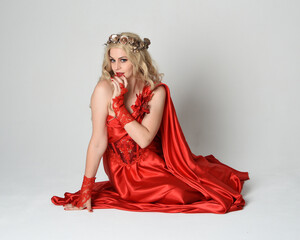 Full length portrait of beautiful blonde model dressed as ancient mythological fantasy goddess in...