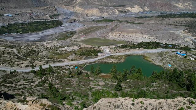 Flying From Above the Mountain Revealing Small Dhumba Lake Fed By Ice from Mount Nilgiri in Mustang District of Nepal - aerial parallax