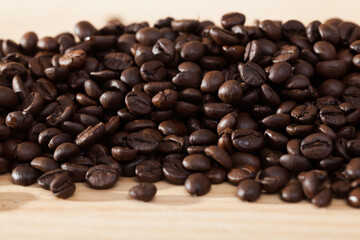 Fototapeta premium Image of fresh coffee beans on natural wooden background, nobody