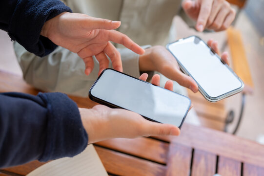 Two people sharing contact info or transferring files by bringing two smartphones close together.