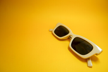 Hipster eyeglasses in pastel frames on a yellow background. Stylish eyeglasses. Retro fashion bold...