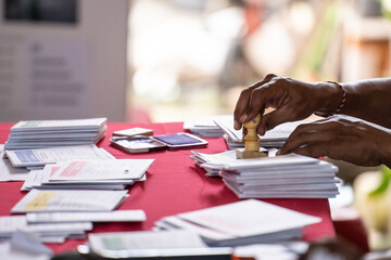 The process of the voting organizer group stamping each paper card for voters in the Indonesian...