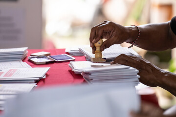 The process of the voting organizer group stamping each paper card for voters in the Indonesian...