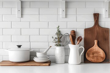 Kitchenware essentials neatly arranged on a kitchen counter against a white tiled wall, aesthetic and minimalist - obrazy, fototapety, plakaty