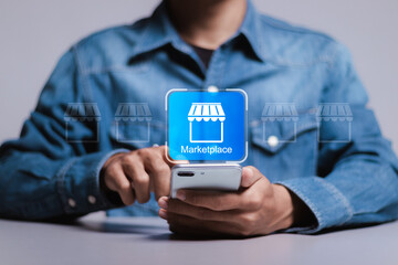 Marketplace concept. Person using smartphone with marketplace icon on virtual screen for online business web technology. Online marketplace e-commerce internet shopping business.
